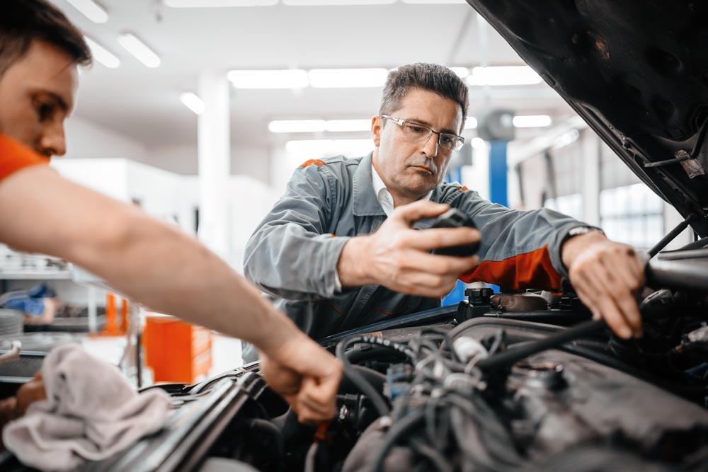 Engineers working on car